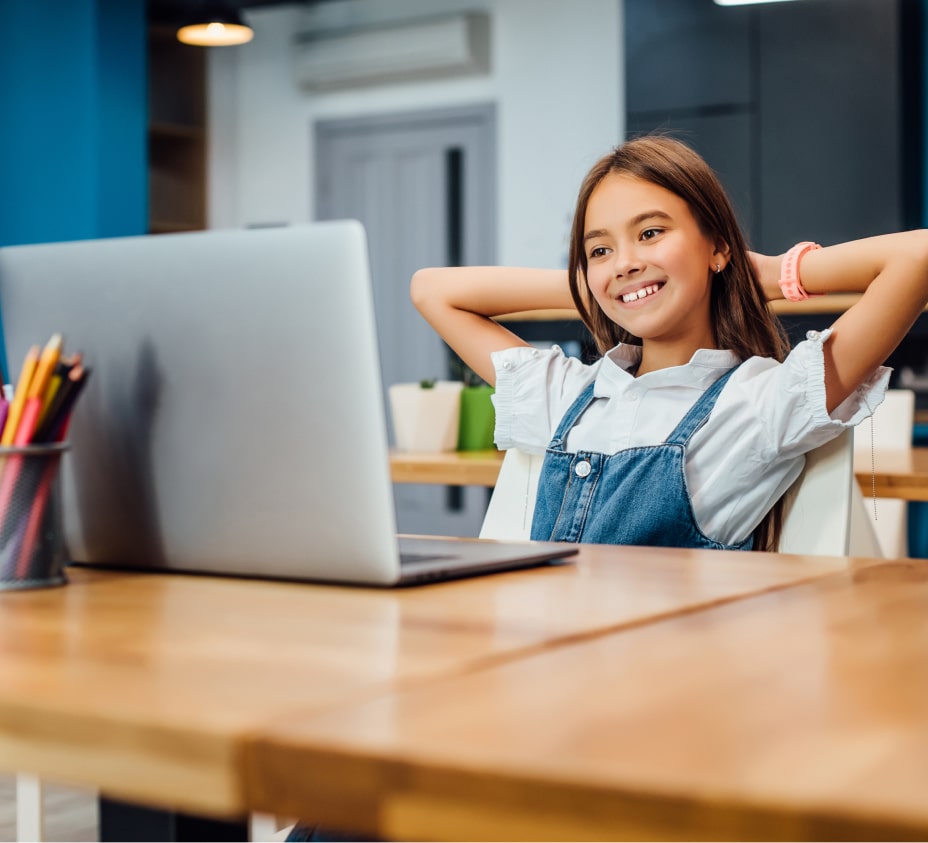Young student smiling at computer during online learning, highlighting Latattore Foundation’s support for accessible education and digital literacy